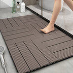 Non-slip plastic floor tiles on a bathroom floor with a person stepping onto them.