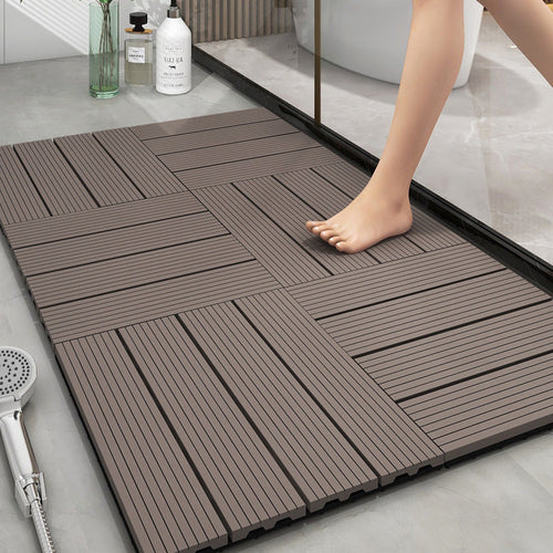 Non-slip plastic floor tiles on a bathroom floor with a person stepping onto them.