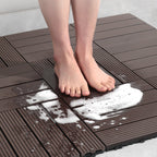 Person standing on a brown interlocking foam mat with soapy water splashes.