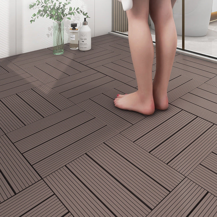 Non-slip plastic flooring tiles with a person standing on them near a glass of water and bottles.