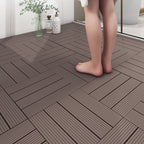 Non-slip plastic flooring tiles with a person standing on them near a glass of water and bottles.