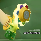 Colorful flower-shaped bubble machine held by a hand on a green background