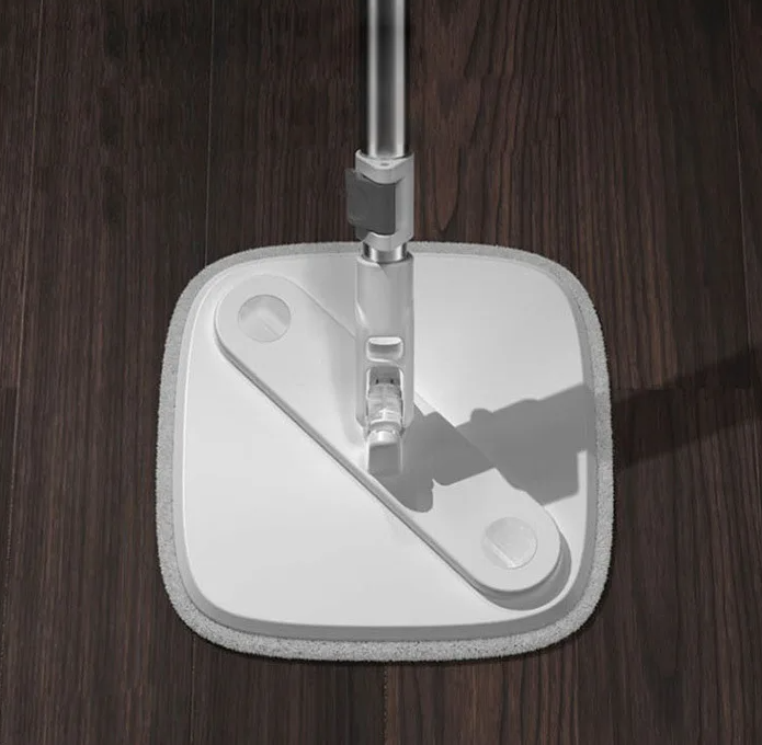 Mop head with a white pad on a wooden floor